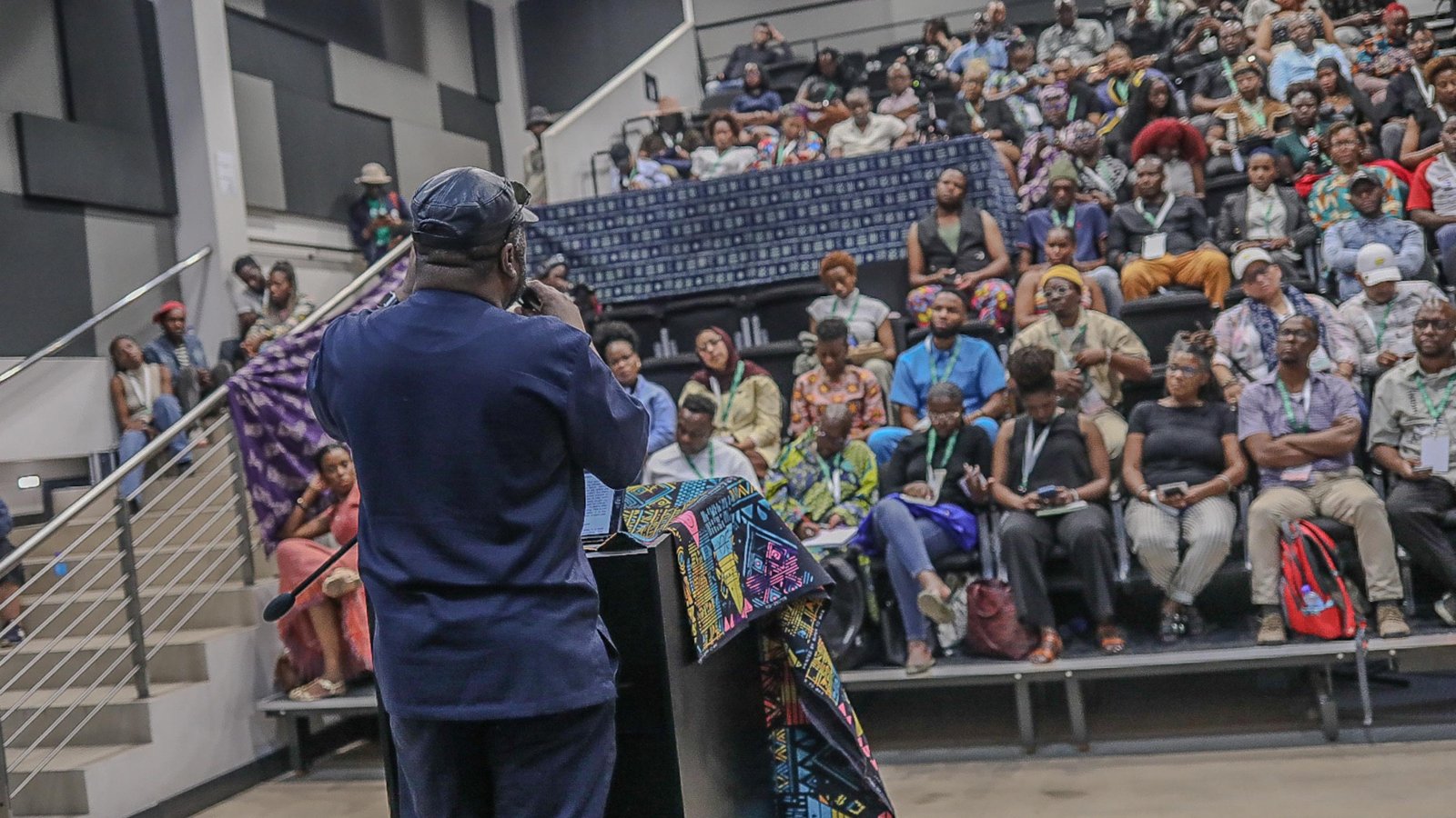 A speaker addresses a packed hall at the Afrotellers Conference 2025